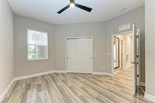 a bathroom with a sink a toilet a mirror and shower