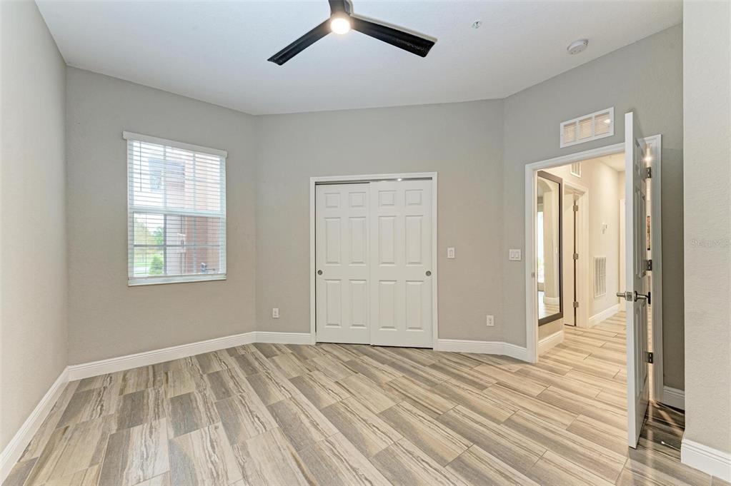 7374 Divot Loop Bradenton, FL 34202 - Photo 20 of 43 a view of an empty room with wooden floor and a window