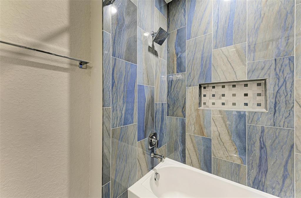 7374 Divot Loop Bradenton, FL 34202 - Photo 21 of 43 a bathroom with a sink a toilet a mirror and shower