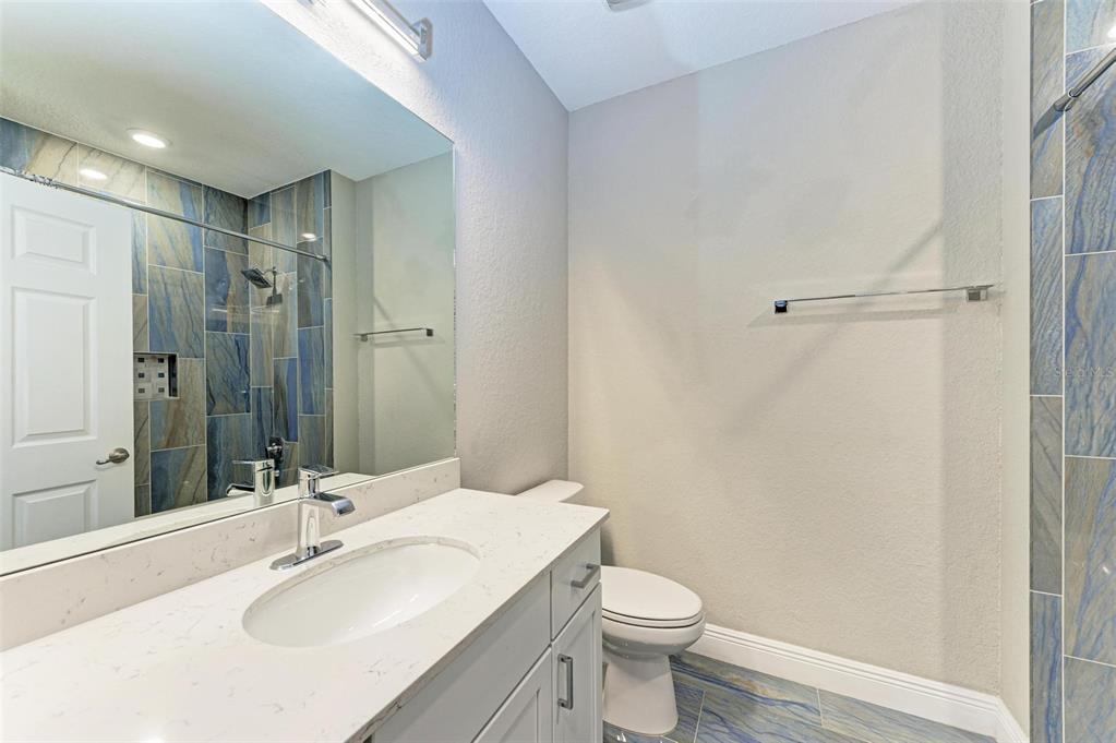 7374 Divot Loop Bradenton, FL 34202 - Photo 22 of 43 a bathroom with a sink toilet and shower