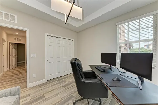 a view of a livingroom with workspace and a couch
