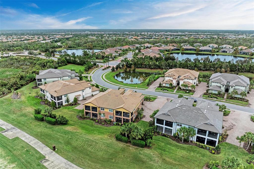 7374 Divot Loop Bradenton, FL 34202 - Photo 29 of 43 an aerial view of multiple houses with a yard