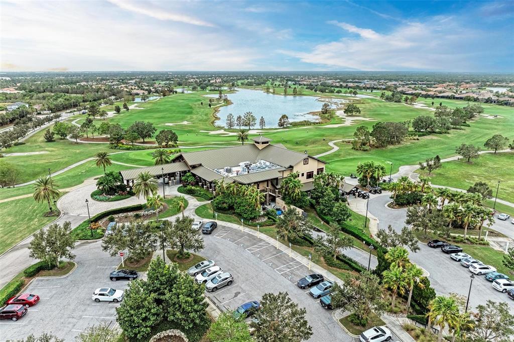 7374 Divot Loop Bradenton, FL 34202 - Photo 32 of 43 an aerial view of a city with lots of residential buildings and mountain view in back