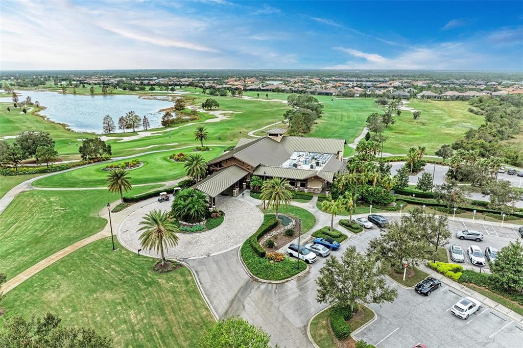 7374 Divot Loop Bradenton, FL 34202 - Photo 33 of 43 an aerial view of a house with yard swimming pool outdoor seating and lake view