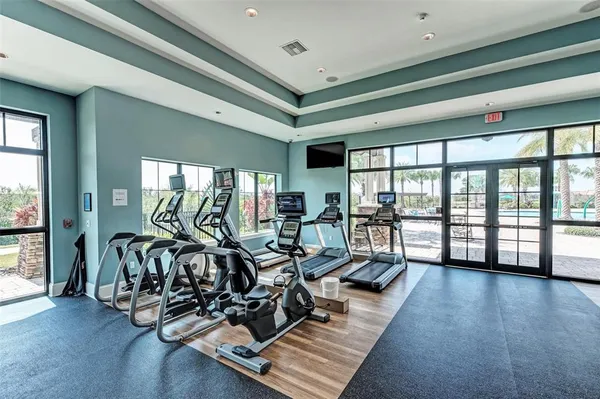 a room with gym equipment and windows