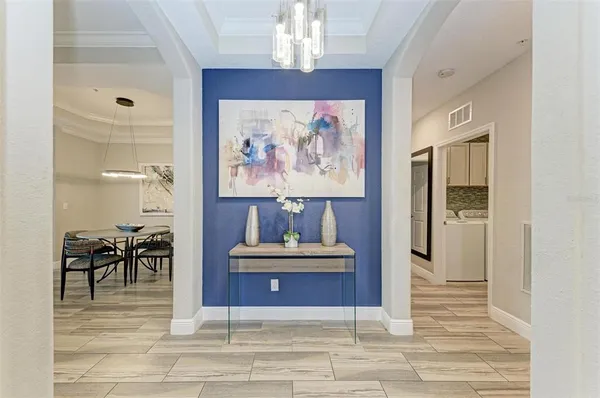 a living room with furniture and a painting on the wall