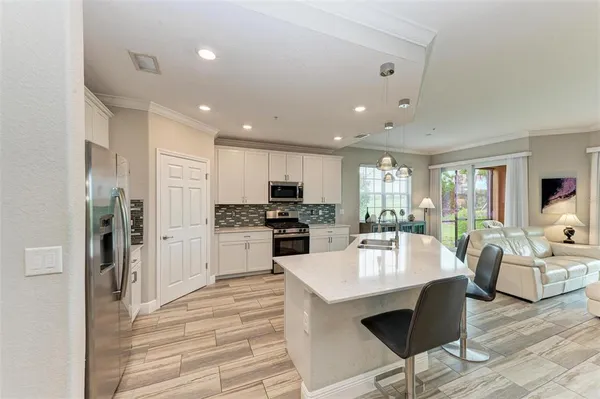 a kitchen with a refrigerator and a stove top oven