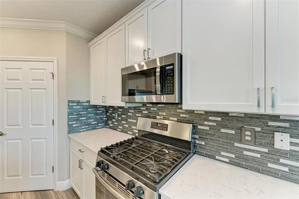 a kitchen with granite countertop a stove and a sink