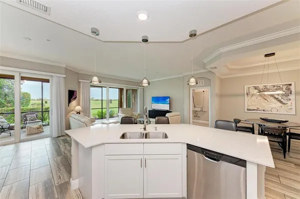 a living room with furniture a flat screen tv and a large window