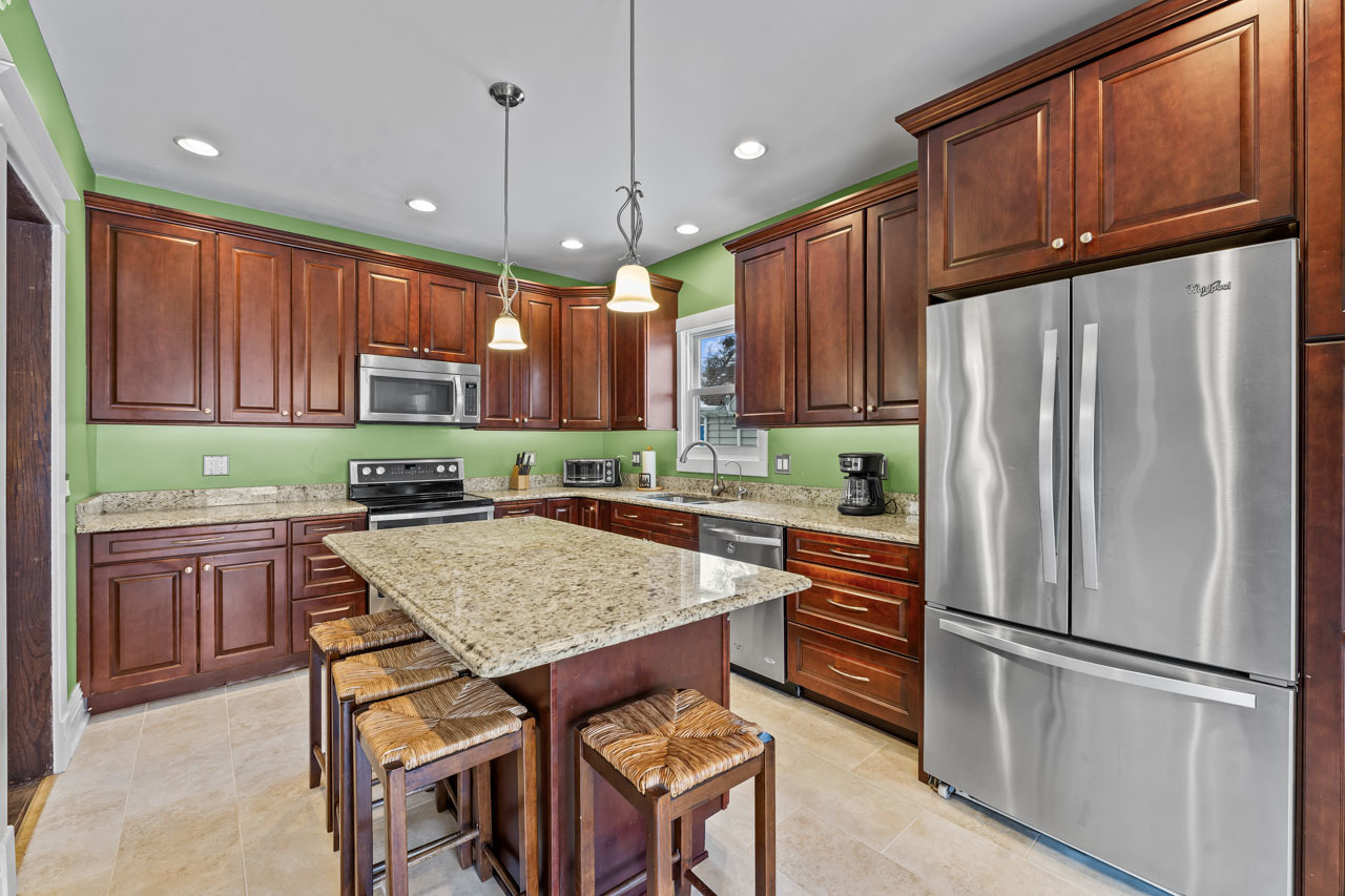 15405 Joliet Road Plainfield, IL 60544 - Photo 11 of 34 a kitchen with stainless steel appliances granite countertop a refrigerator a sink dishwasher a stove and white cabinets with wooden floor