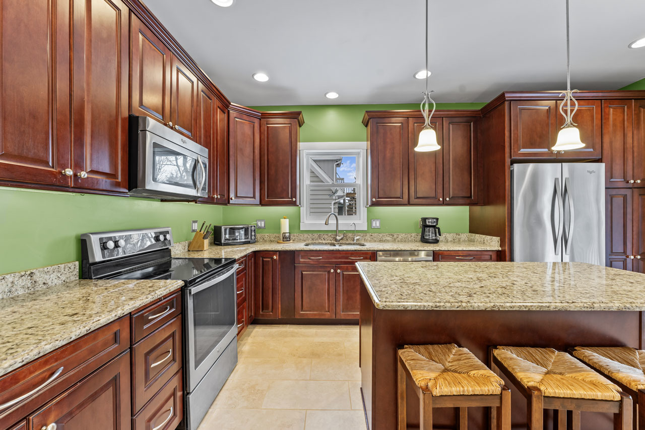 15405 Joliet Road Plainfield, IL 60544 - Photo 9 of 34 a kitchen with stainless steel appliances granite countertop a stove a sink and a refrigerator