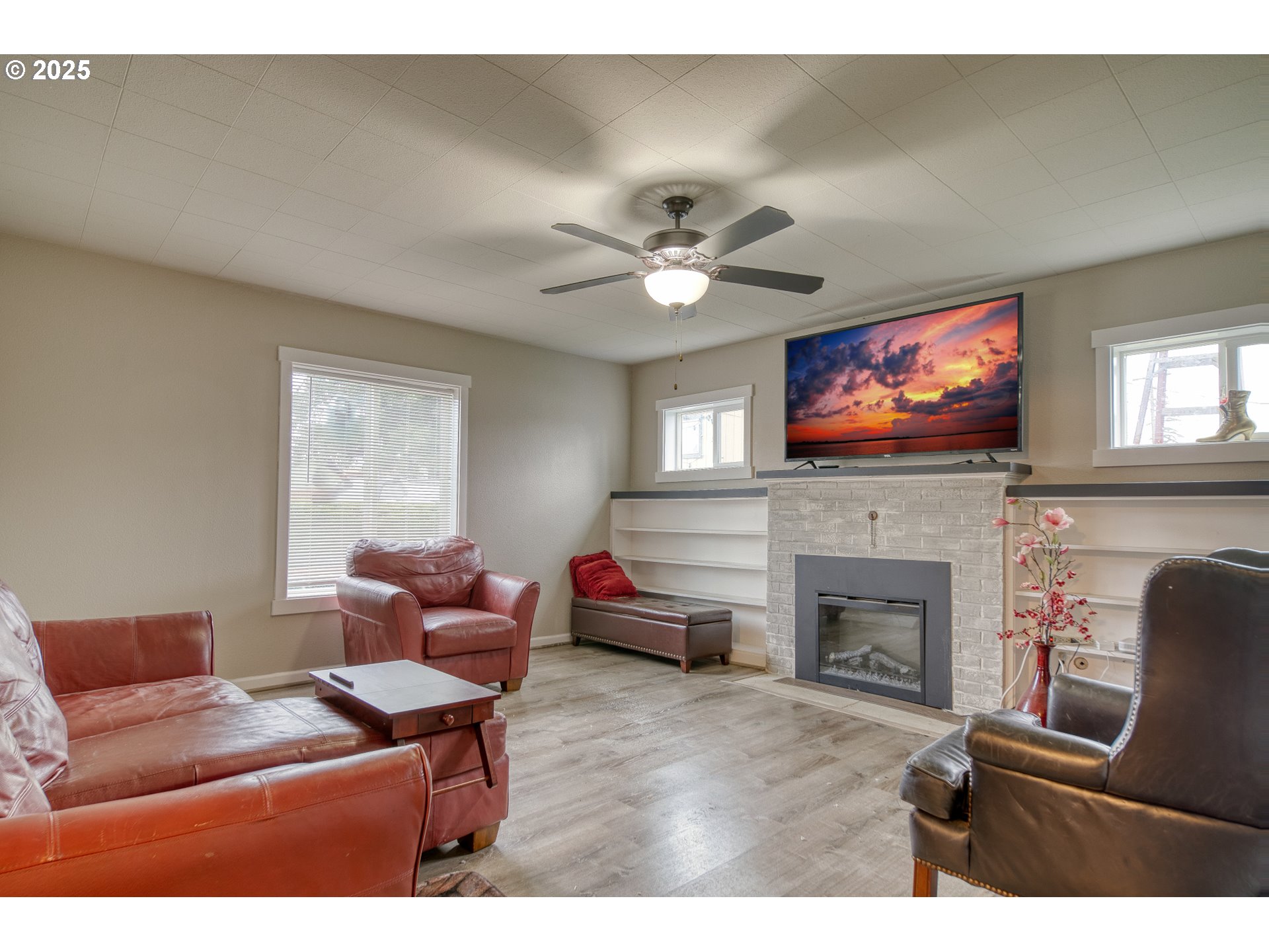 385 North 6th Street St. Helens, OR 97051 - Photo 5 of 23 a living room with furniture a fireplace and a flat screen tv