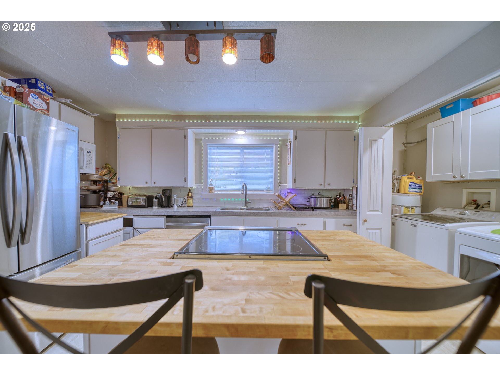 385 North 6th Street St. Helens, OR 97051 - Photo 10 of 23 a large kitchen with stainless steel appliances kitchen island granite countertop a refrigerator a stove and a sink