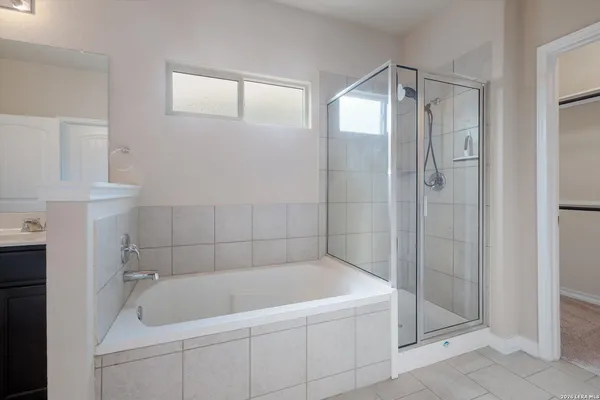 a white bath tub sitting next to a shower