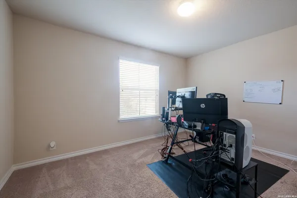 a view of a workspace with furniture and a window