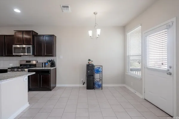 a kitchen with granite countertop a stove and a refrigerator