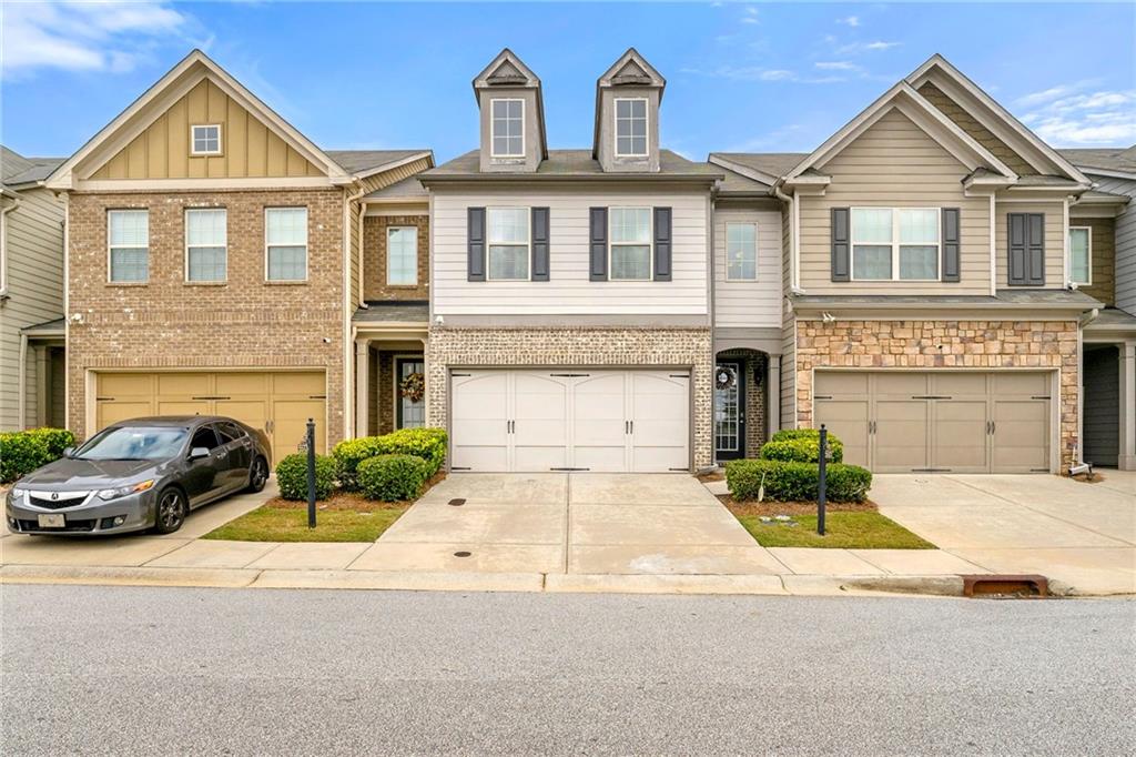 a front view of a house with parking area