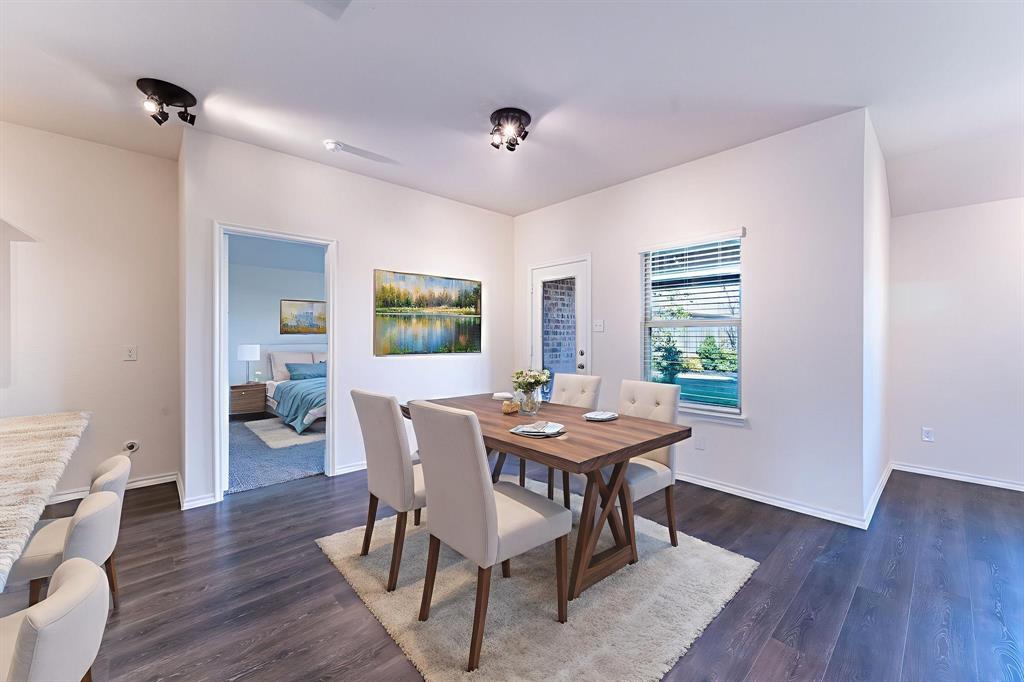 2101 Brisbon Street Fate, TX 75189 - Photo 11 of 39 a view of a dining room with furniture and wooden floor