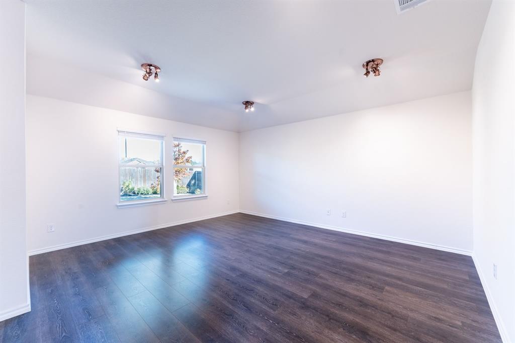 2101 Brisbon Street Fate, TX 75189 - Photo 15 of 39 an empty room with wooden floor and window