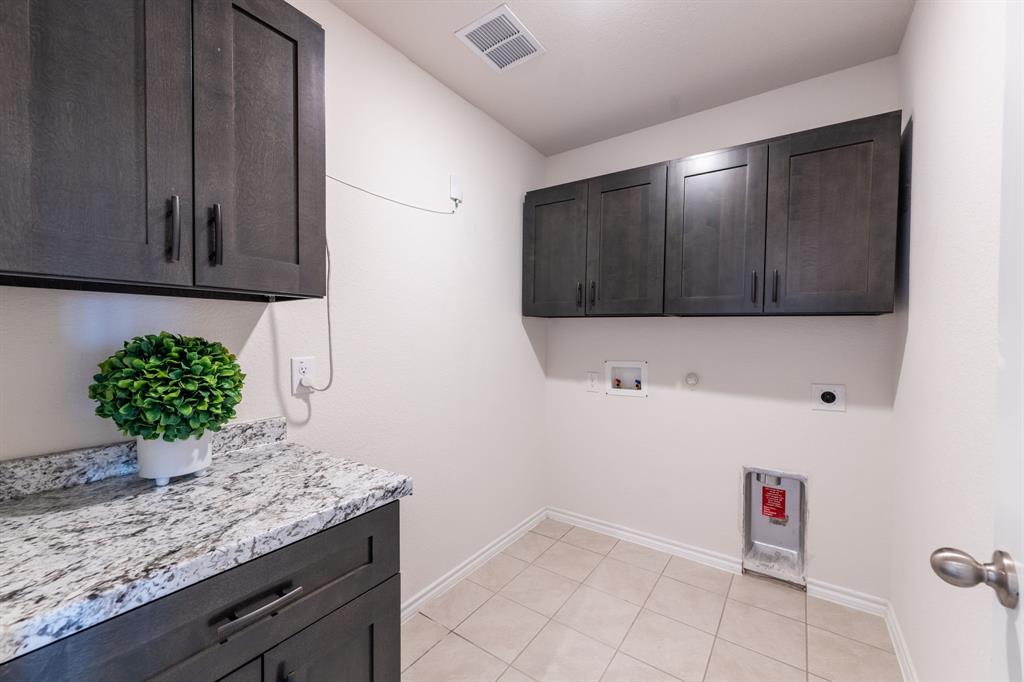 2101 Brisbon Street Fate, TX 75189 - Photo 29 of 39 a kitchen with a sink and a microwave