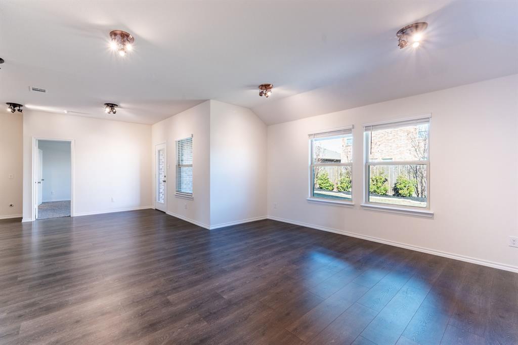 2101 Brisbon Street Fate, TX 75189 - Photo 10 of 39 an empty room with wooden floor and windows