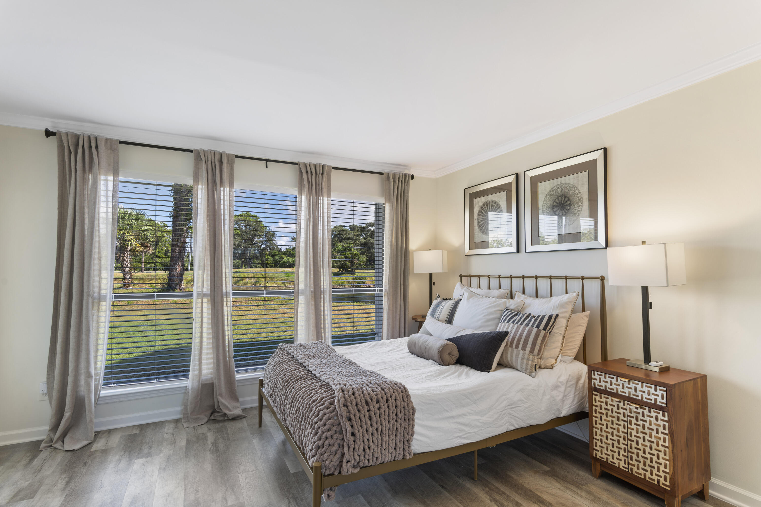 4300 Bay Point Road, Unit 402 Panama City Beach, FL 32408 - Photo 16 of 34 a bedroom with a bed and wooden floor