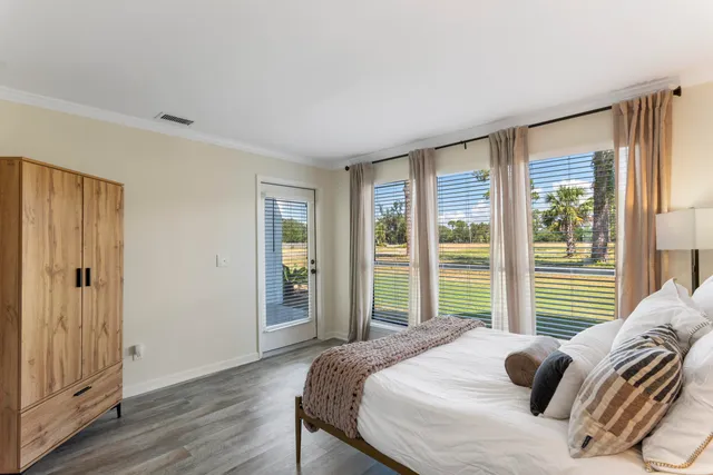 a bedroom with a bed and glass window