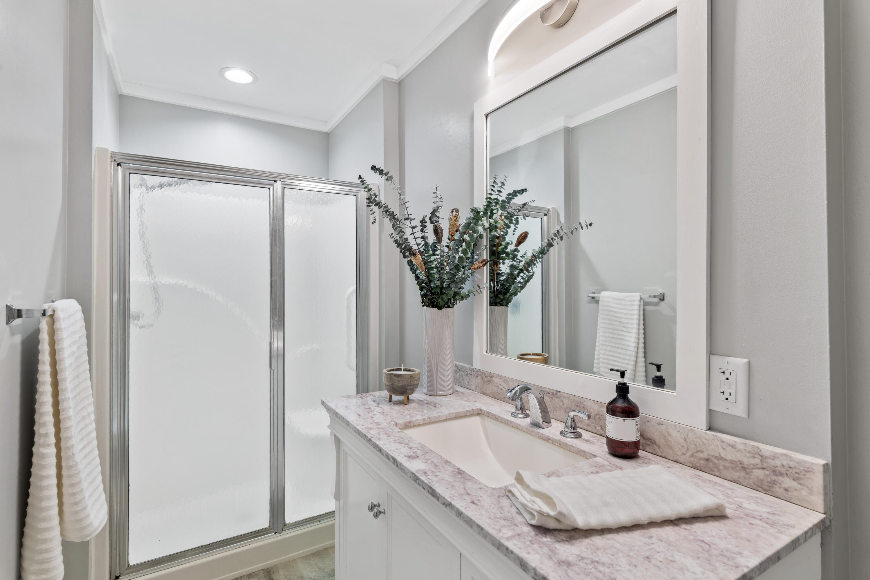 4300 Bay Point Road, Unit 402 Panama City Beach, FL 32408 - Photo 18 of 34 a bathroom with a granite countertop sink and a mirror