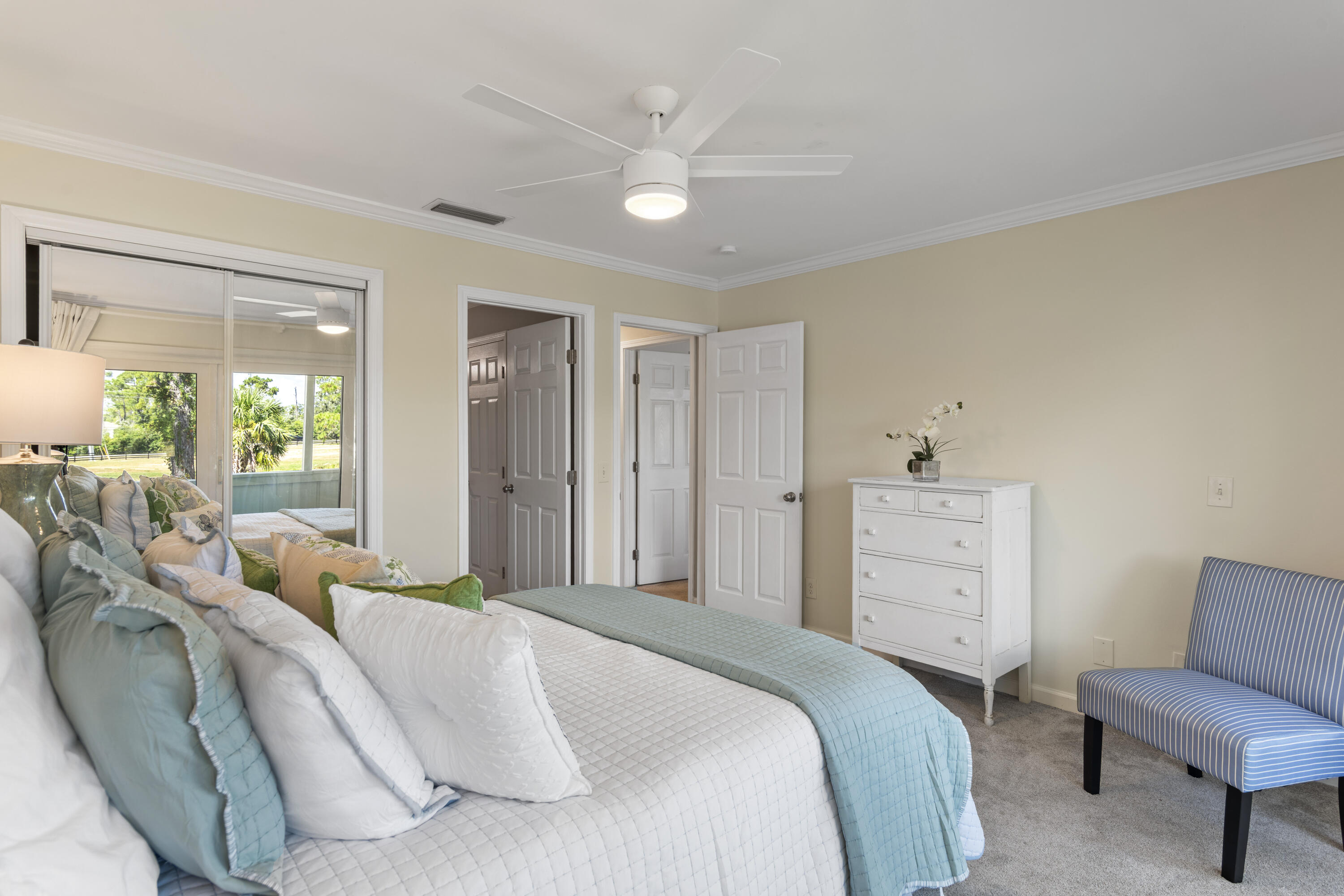 4300 Bay Point Road, Unit 402 Panama City Beach, FL 32408 - Photo 22 of 34 a bedroom with a bed and a chair