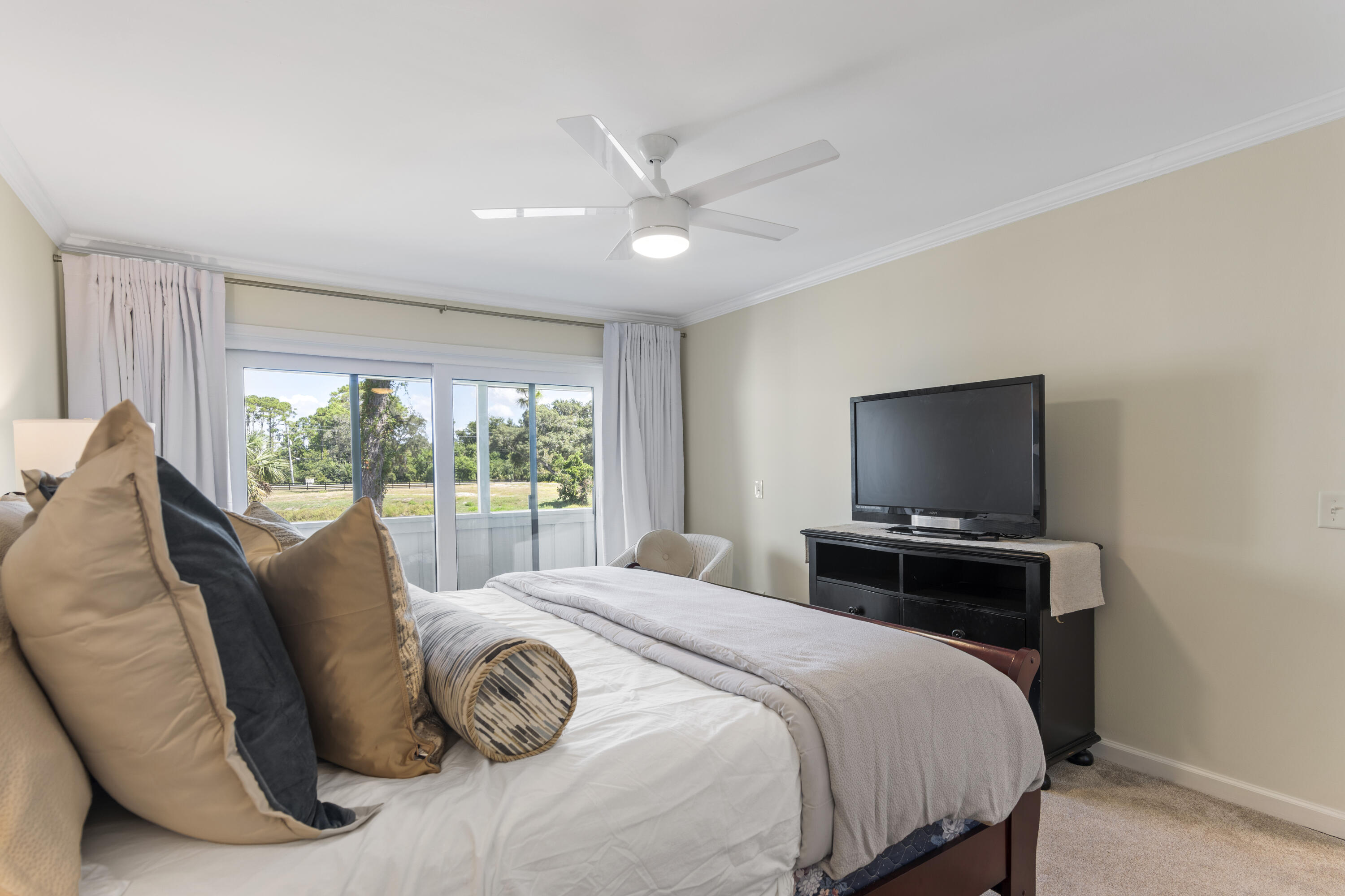 4300 Bay Point Road, Unit 402 Panama City Beach, FL 32408 - Photo 26 of 34 a bedroom with a bed and a flat screen tv