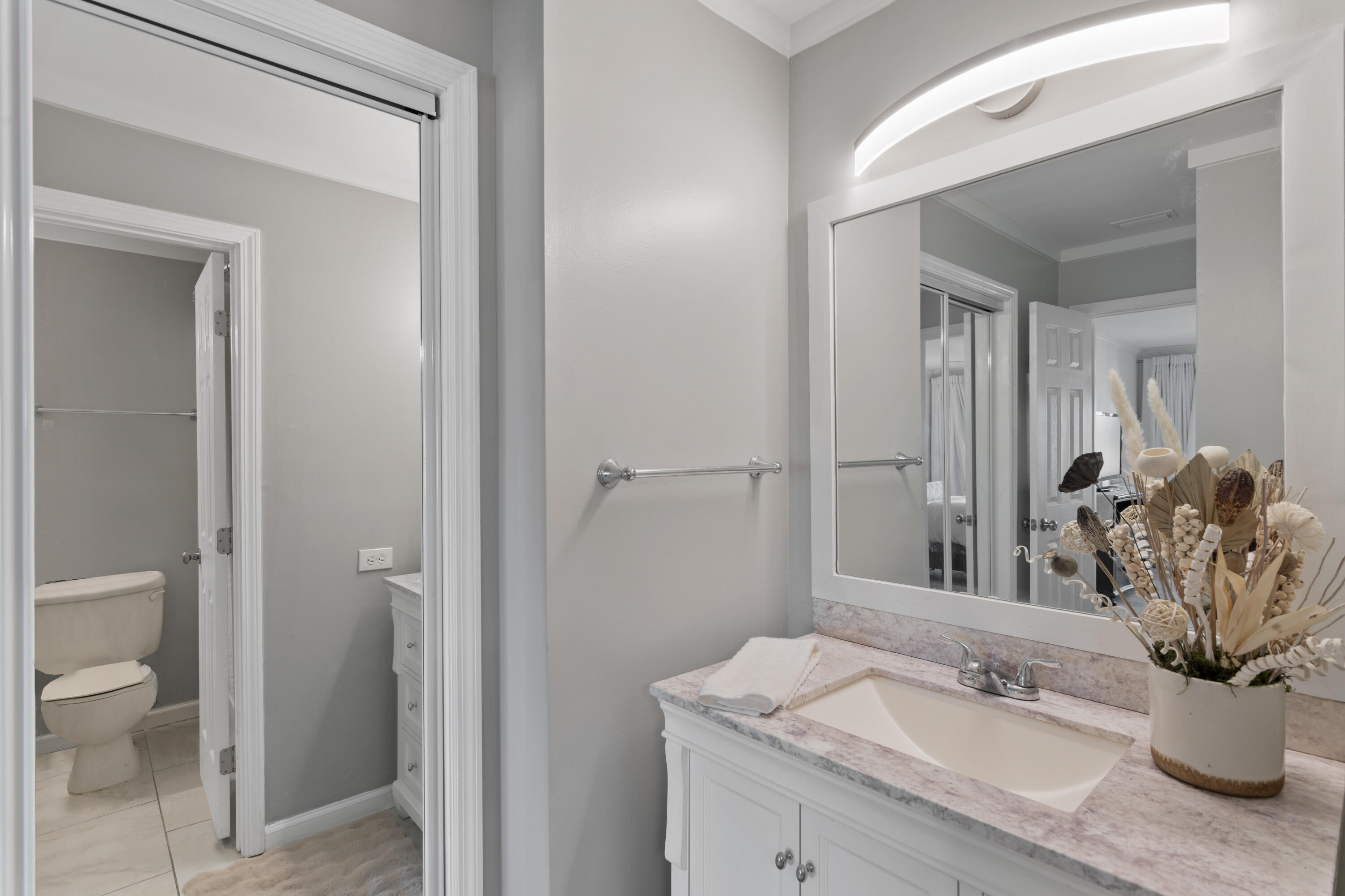 4300 Bay Point Road, Unit 402 Panama City Beach, FL 32408 - Photo 29 of 34 a bathroom with a granite countertop sink a toilet and shower