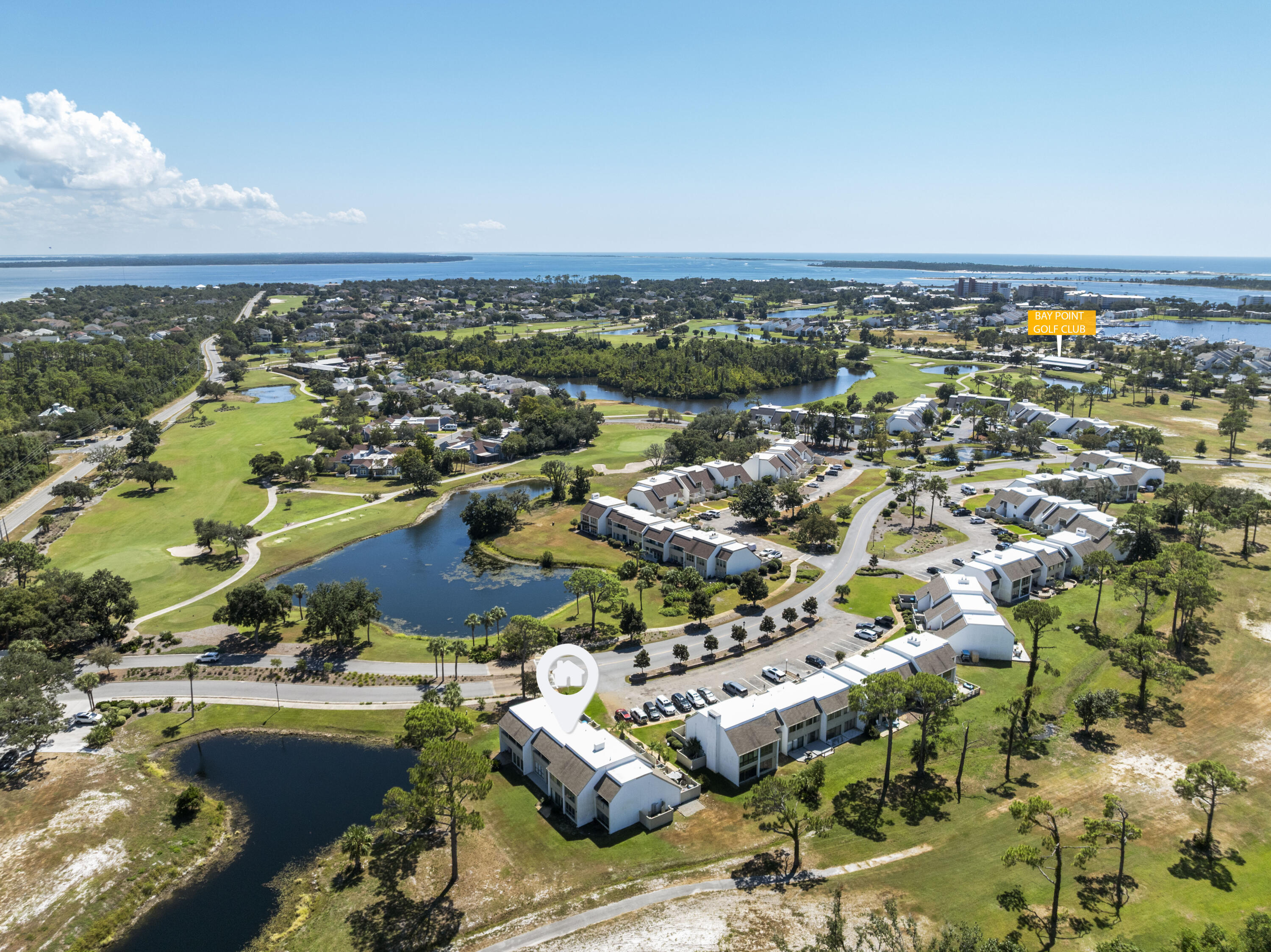 4300 Bay Point Road, Unit 402 Panama City Beach, FL 32408 - Photo 4 of 34 an aerial view of a city with lots of residential buildings and ocean view in back