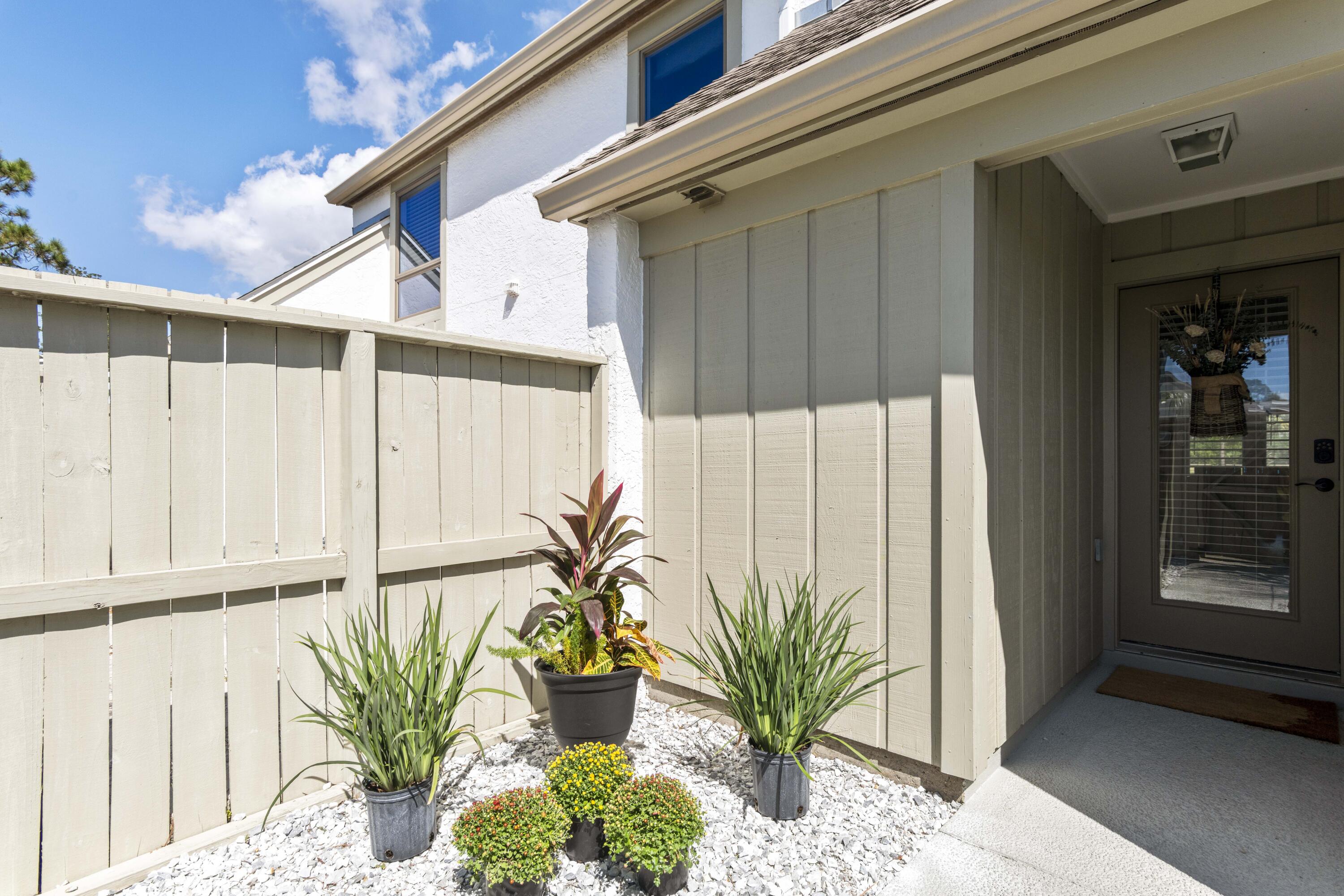 4300 Bay Point Road, Unit 402 Panama City Beach, FL 32408 - Photo 6 of 34 a potted plant sitting in front of a door