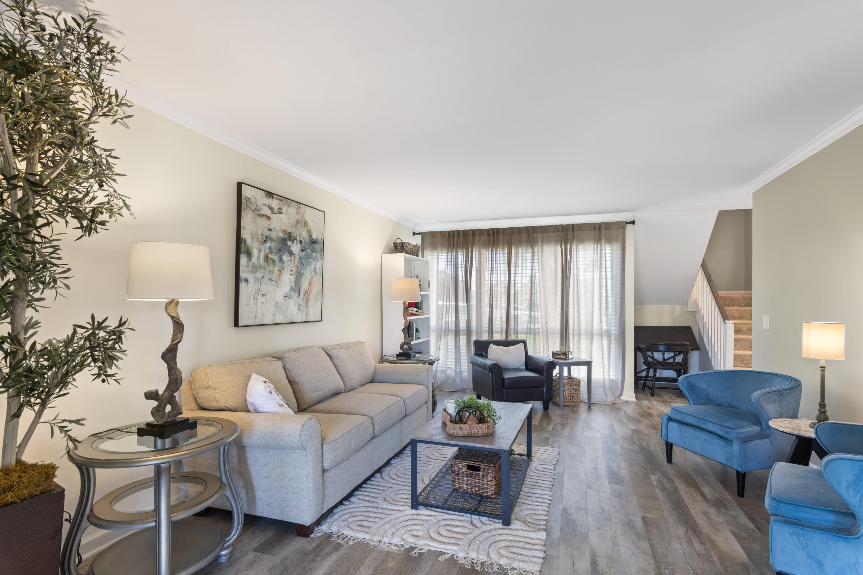 4300 Bay Point Road, Unit 402 Panama City Beach, FL 32408 - Photo 7 of 34 a living room with furniture and wooden floor