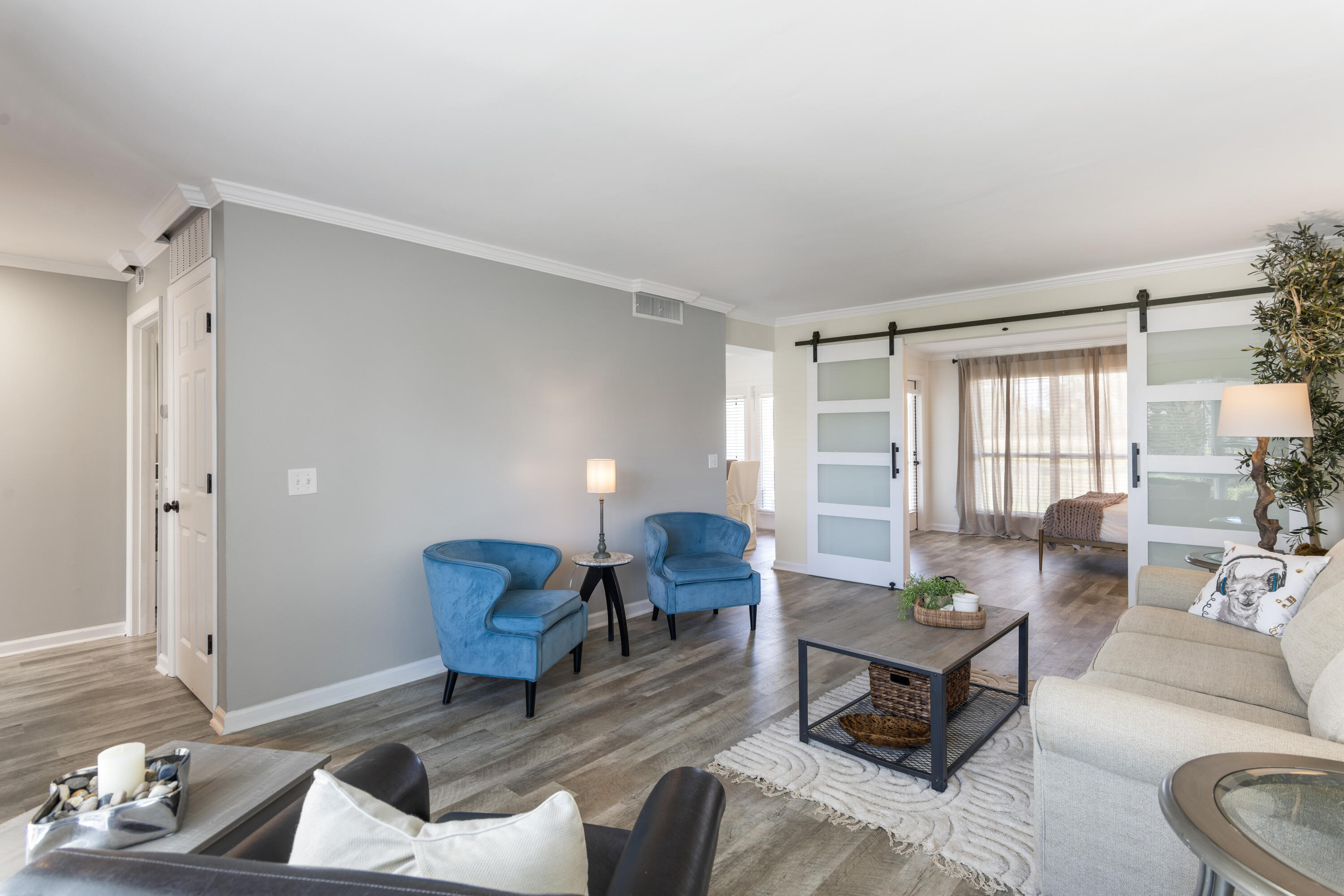 4300 Bay Point Road, Unit 402 Panama City Beach, FL 32408 - Photo 8 of 34 a living room with furniture and wooden floor