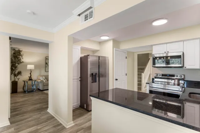 a kitchen with stainless steel appliances granite countertop a refrigerator and a stove