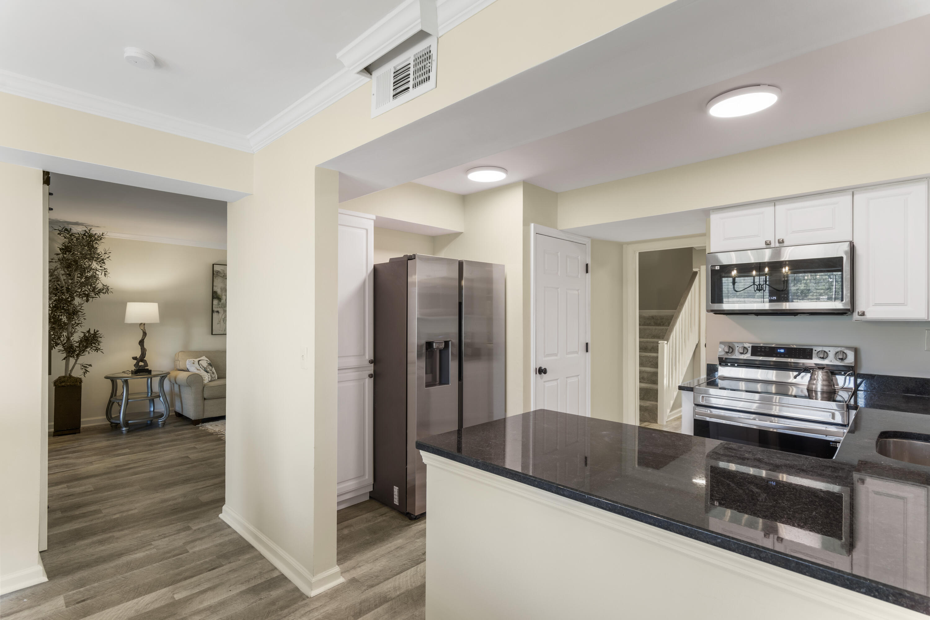 4300 Bay Point Road, Unit 402 Panama City Beach, FL 32408 - Photo 9 of 34 a kitchen with stainless steel appliances granite countertop a refrigerator and a stove