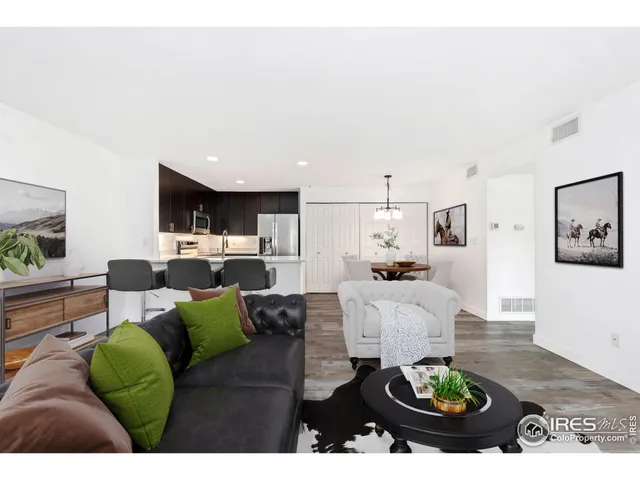 a living room with furniture and kitchen view