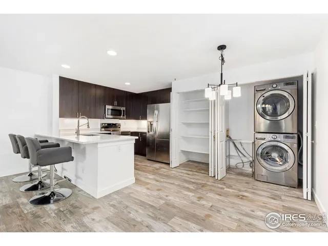 a kitchen with a refrigerator and a stove