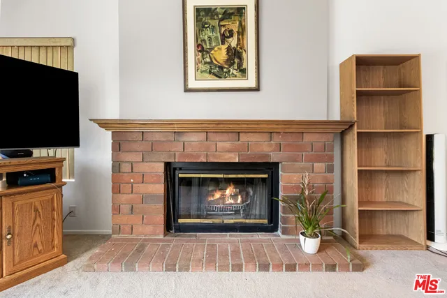 a living room with a fireplace and a flat screen tv