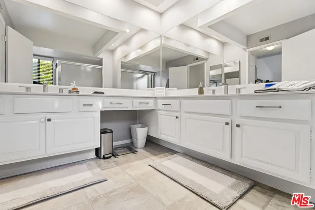 a kitchen with a sink cabinets and appliances