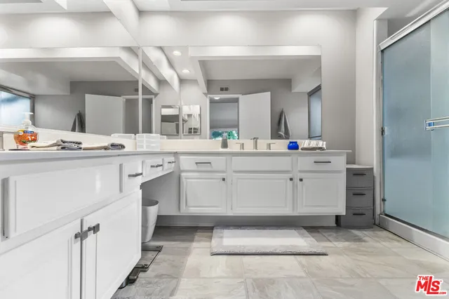 a utility room with cabinets washer and dryer