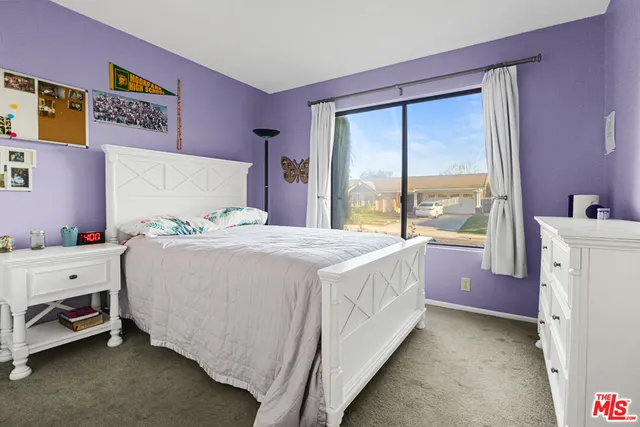 a bed room with a bed and a large window