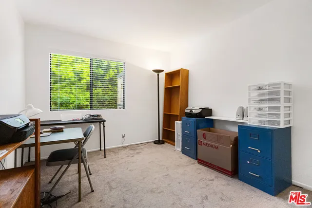 a view of a house with swimming pool lawn chairs and floor to ceiling window