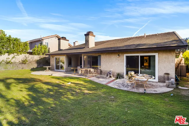 a view of a swimming pool with an outdoor space and seating area