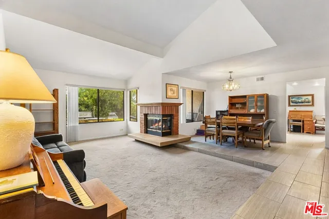 a living room with furniture a window and a fireplace