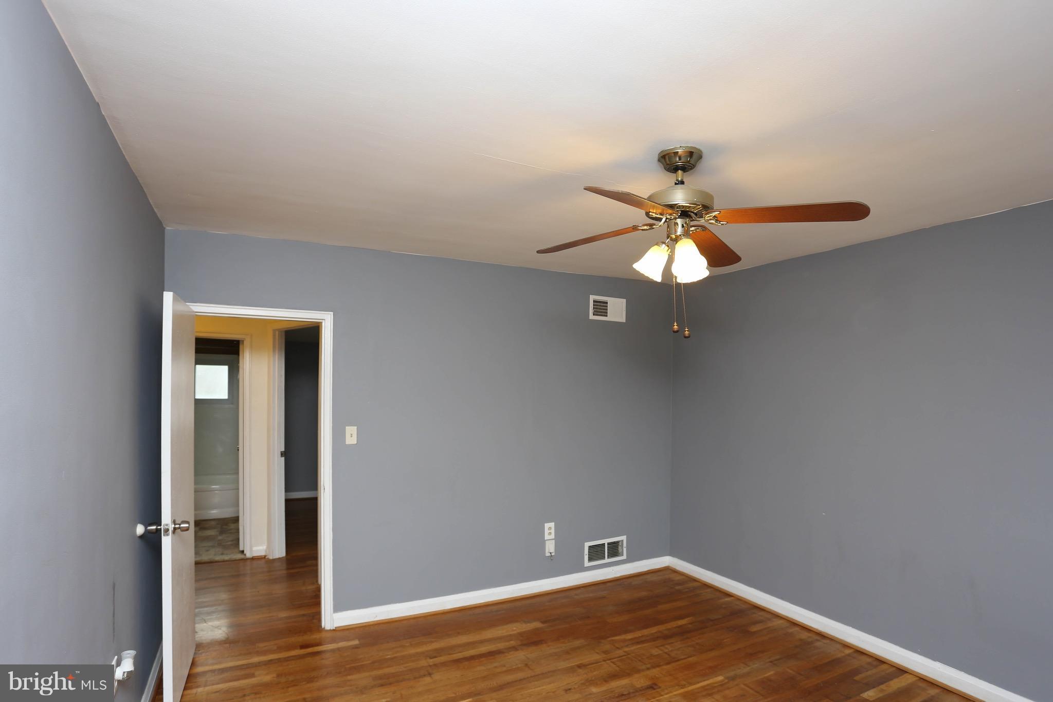 1957 Holborn Road Baltimore, MD 21222 - Photo 14 of 25 wooden floor in an empty room with a window