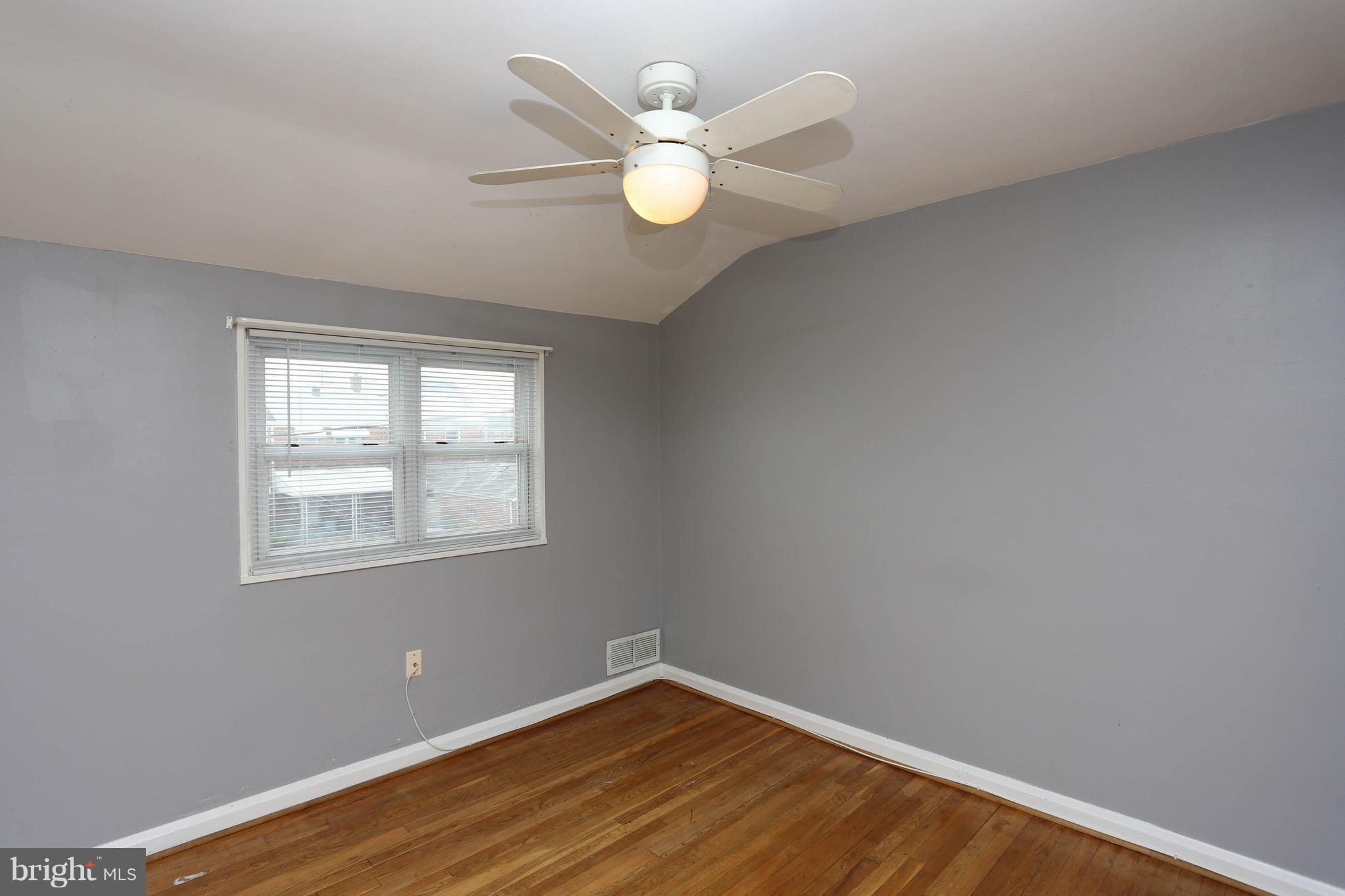 1957 Holborn Road Baltimore, MD 21222 - Photo 16 of 25 an empty room with wooden floor and windows
