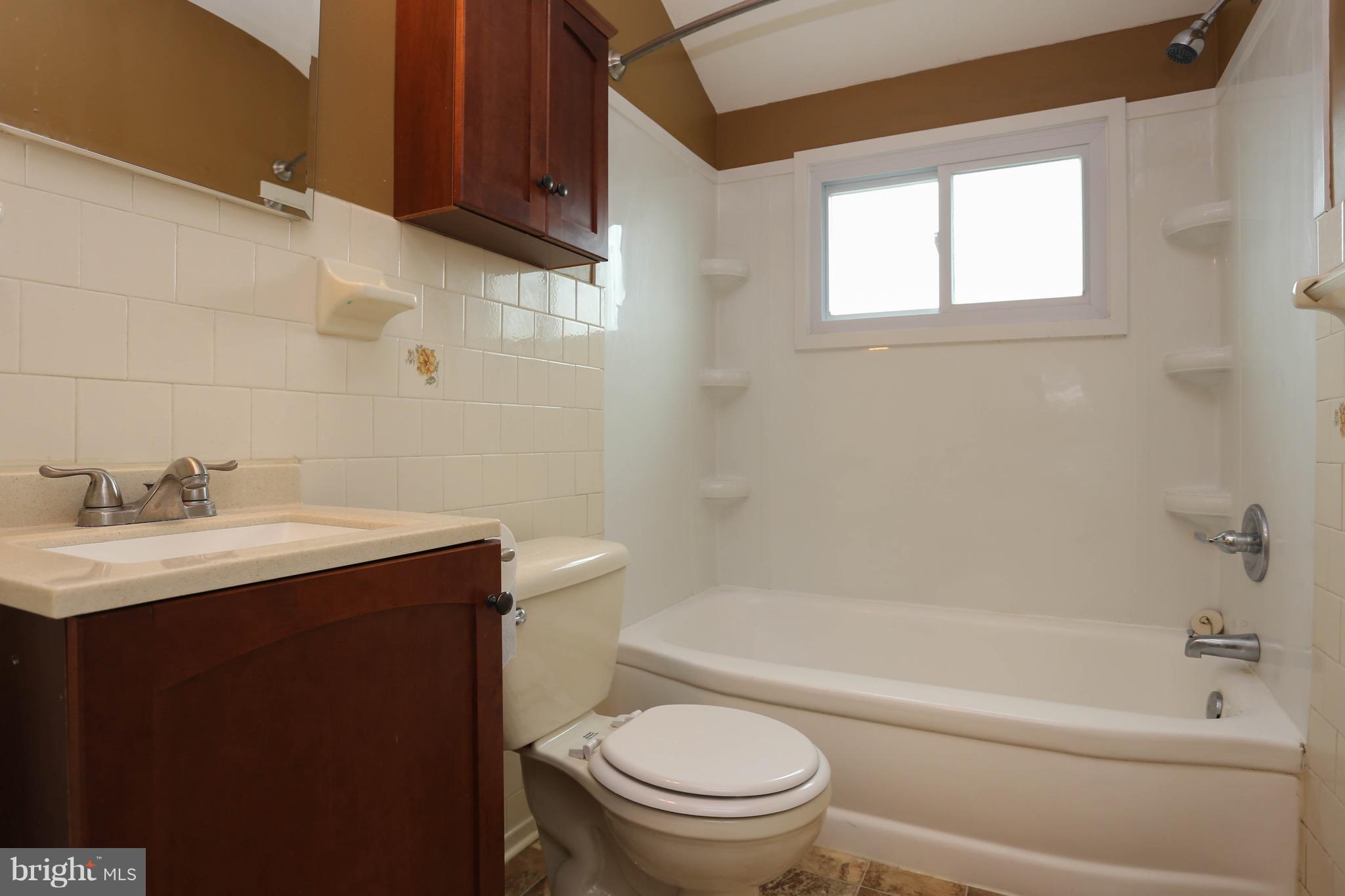 1957 Holborn Road Baltimore, MD 21222 - Photo 17 of 25 a bathroom with a sink a toilet and bathtub