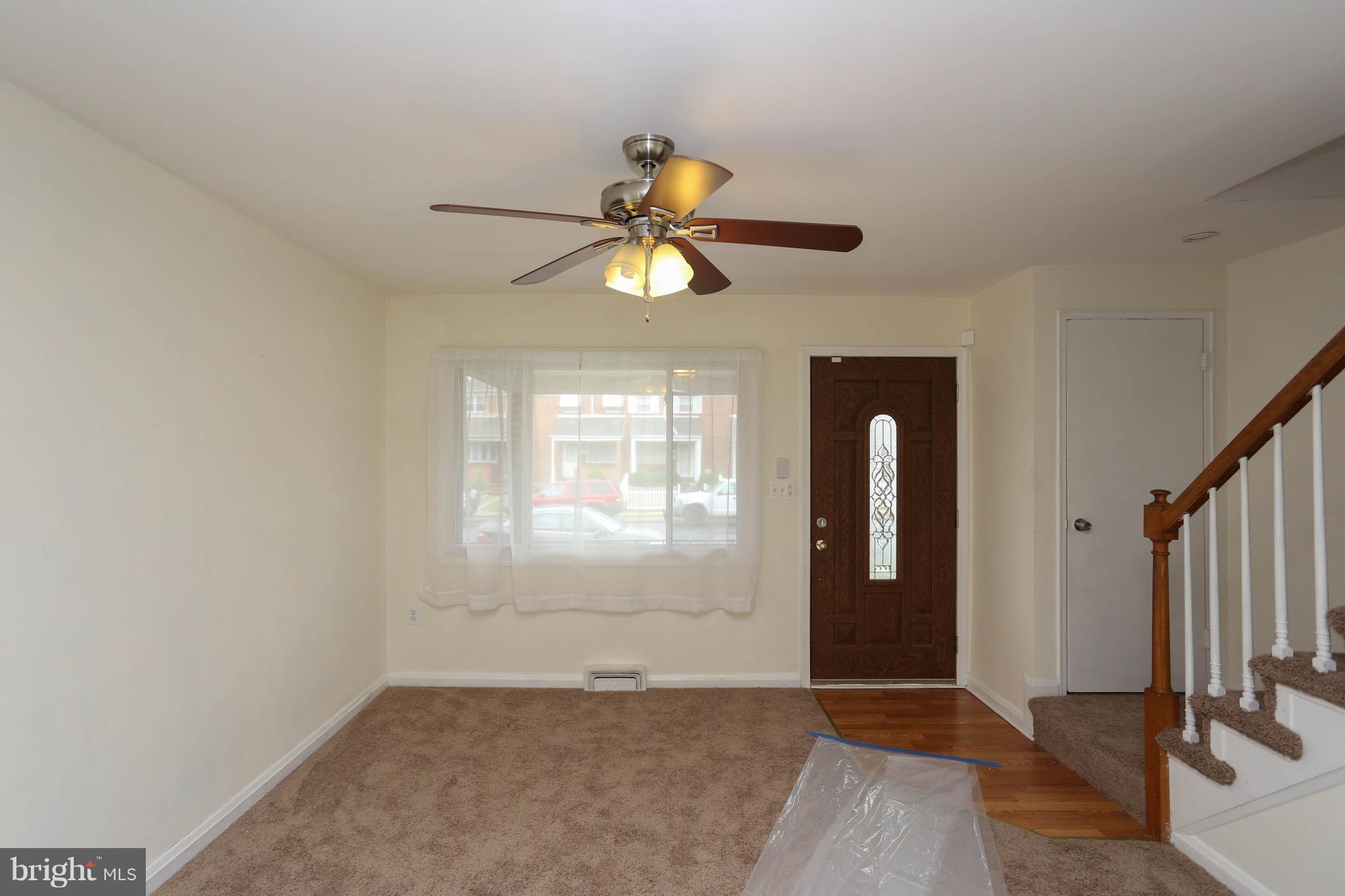 1957 Holborn Road Baltimore, MD 21222 - Photo 5 of 25 wooden floor in an empty room with a window